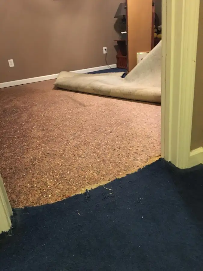 Carpet pad removal revealing water damage during Drying & Dehumidification in Royal Kunia